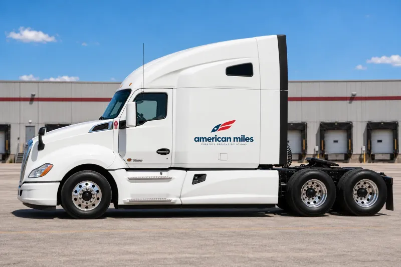 White Kenworth T680 sleeper tractor in American Miles livery, side view