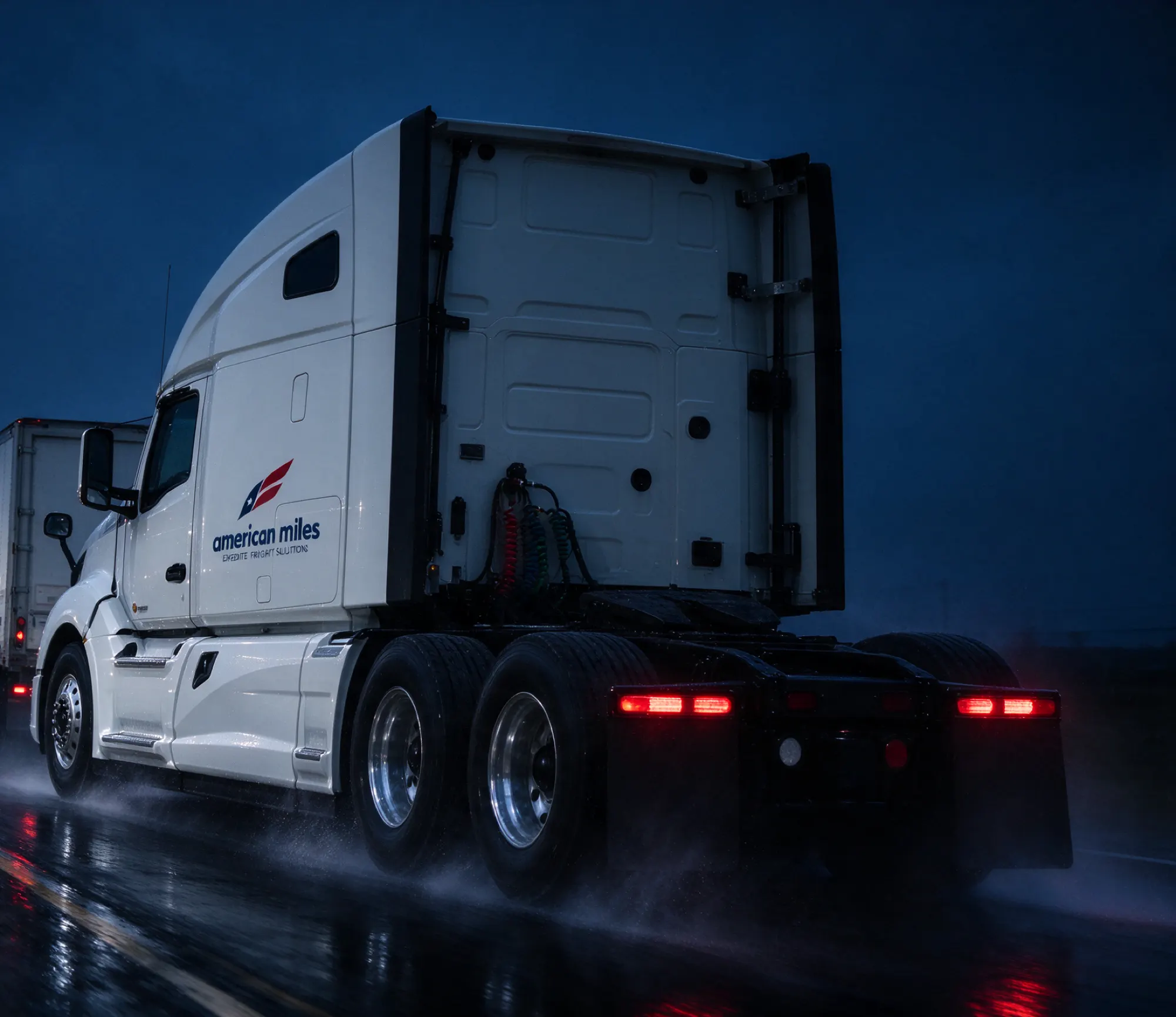 American Miles Kenworth T680 heading out on a wet highway before dawn